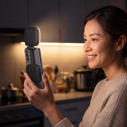 The black Studio light on the back of a phone, turned over the top edge to light a woman's face on a video call
